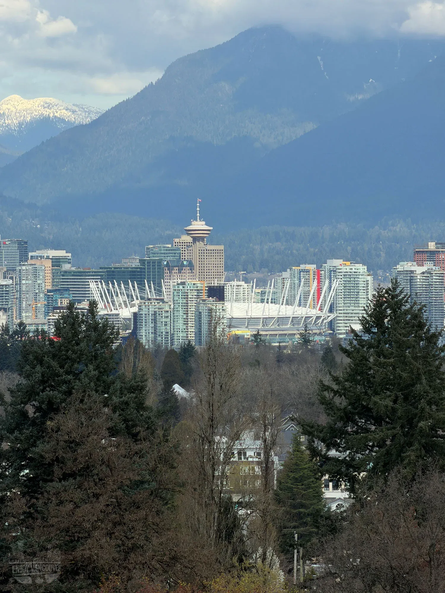 Panoramic view of Vancouver city skyline and North Shore mountains from Queen Elizabeth Park