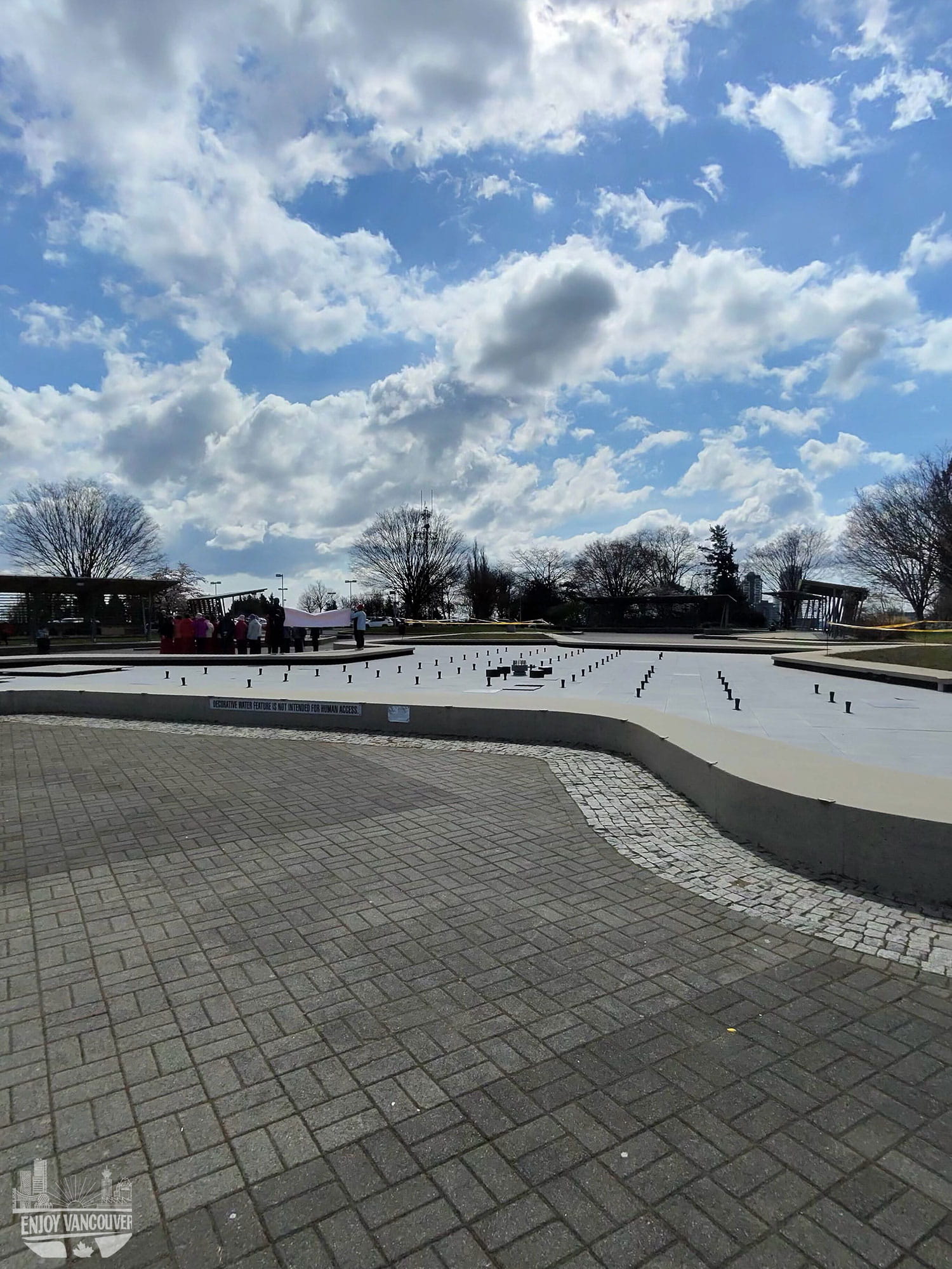 Larry Berg Flight Path Park central map sculpture and cherry blossoms Richmond