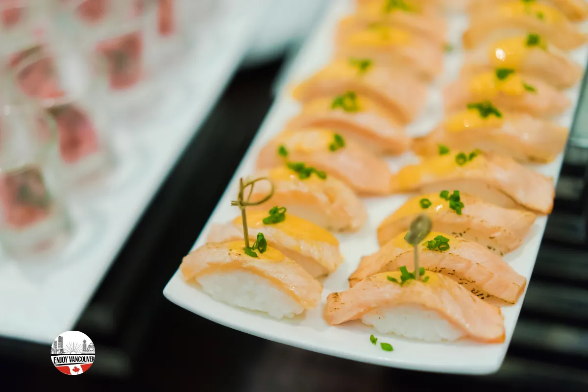 Assorted sushi arranged on a ceramic platter with chopsticks