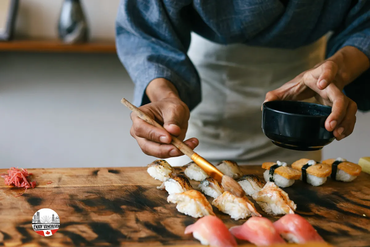 Sushi chef preparing nigiri at a restaurant counter